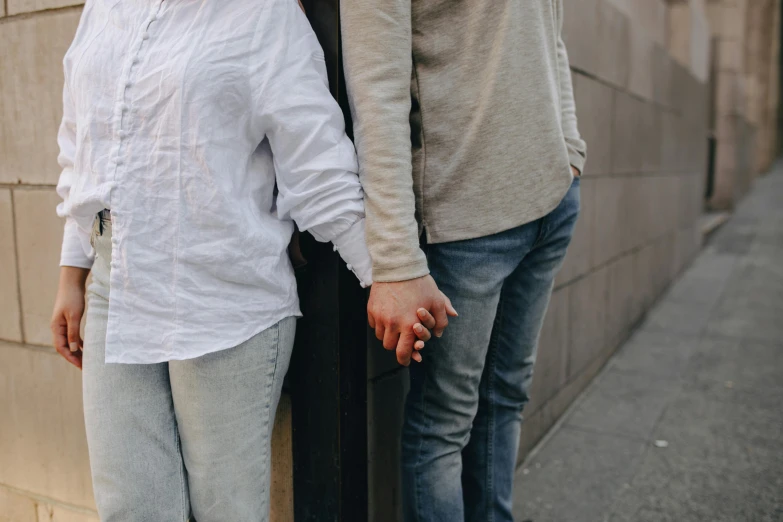 a man and a woman standing next to each other, trending on pexels, hands not visible, lgbt, background image, romantic lead