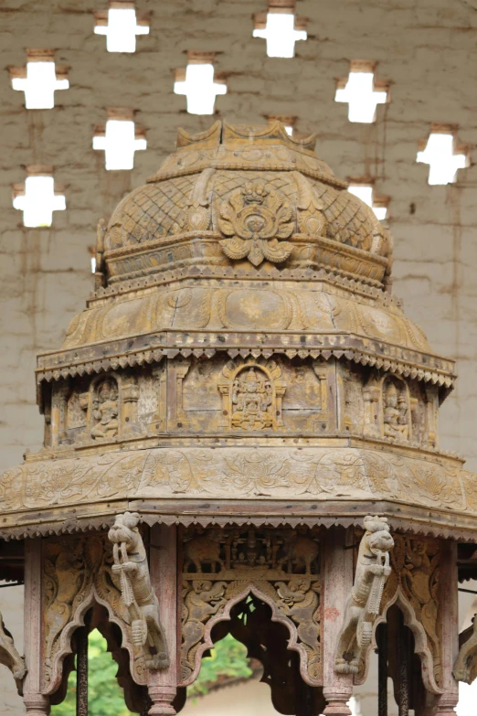 a man standing in front of a stone structure, a marble sculpture, folk art, intricate detailed roof, carved in wood, tomb, hexagonal shaped