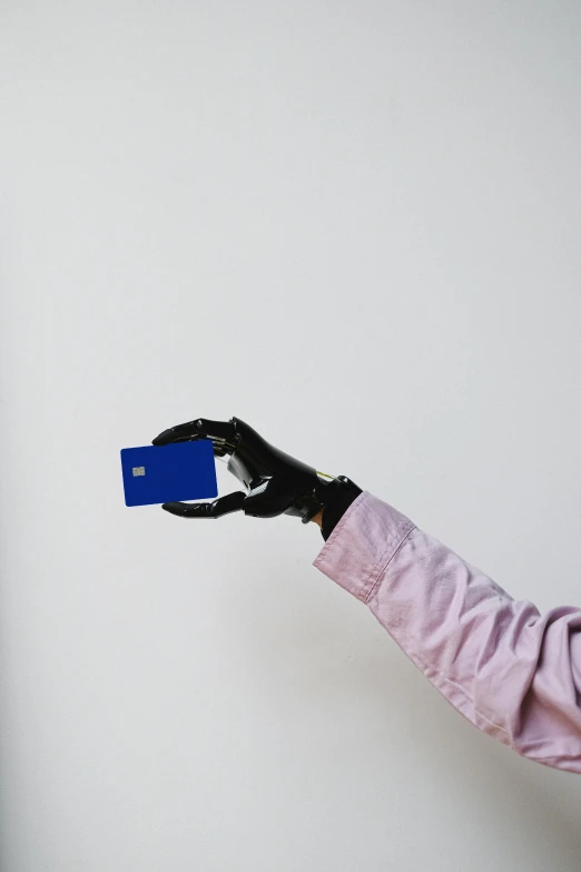 a person holding a blue card in their hand, an album cover, inspired by Yves Klein, unsplash, visual art, microchips, wearing gloves, high quality photo, mid-view