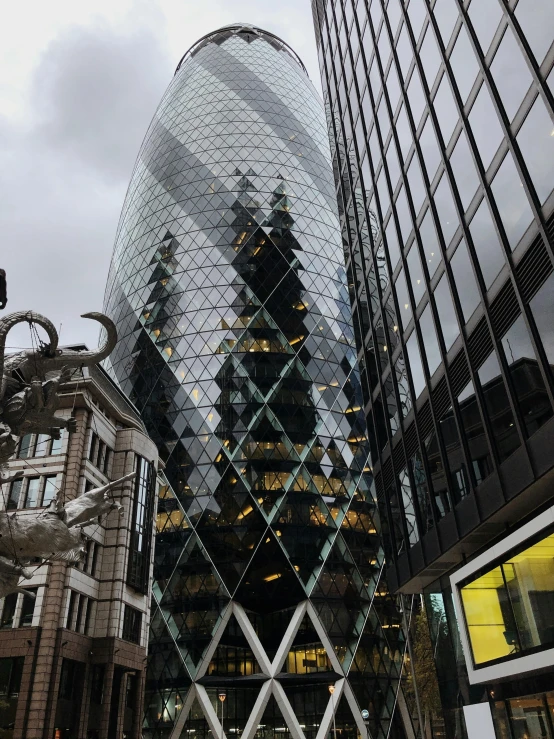 the gherni building towering over the city of london, an album cover, nice slight overcast weather, low quality photo, cone shaped, snapchat photo