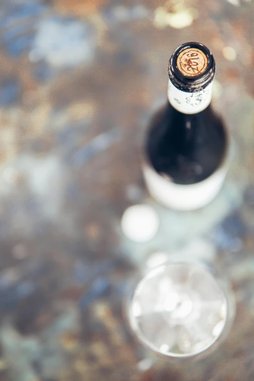 a bottle of wine sitting on top of a table, by Jan Tengnagel, unsplash, renaissance, surface with beer-texture, high angle close up shot, 15081959 21121991 01012000 4k, shiny crisp finish