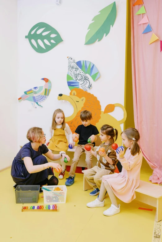 a group of children sitting on top of a yellow floor, a room, toy room