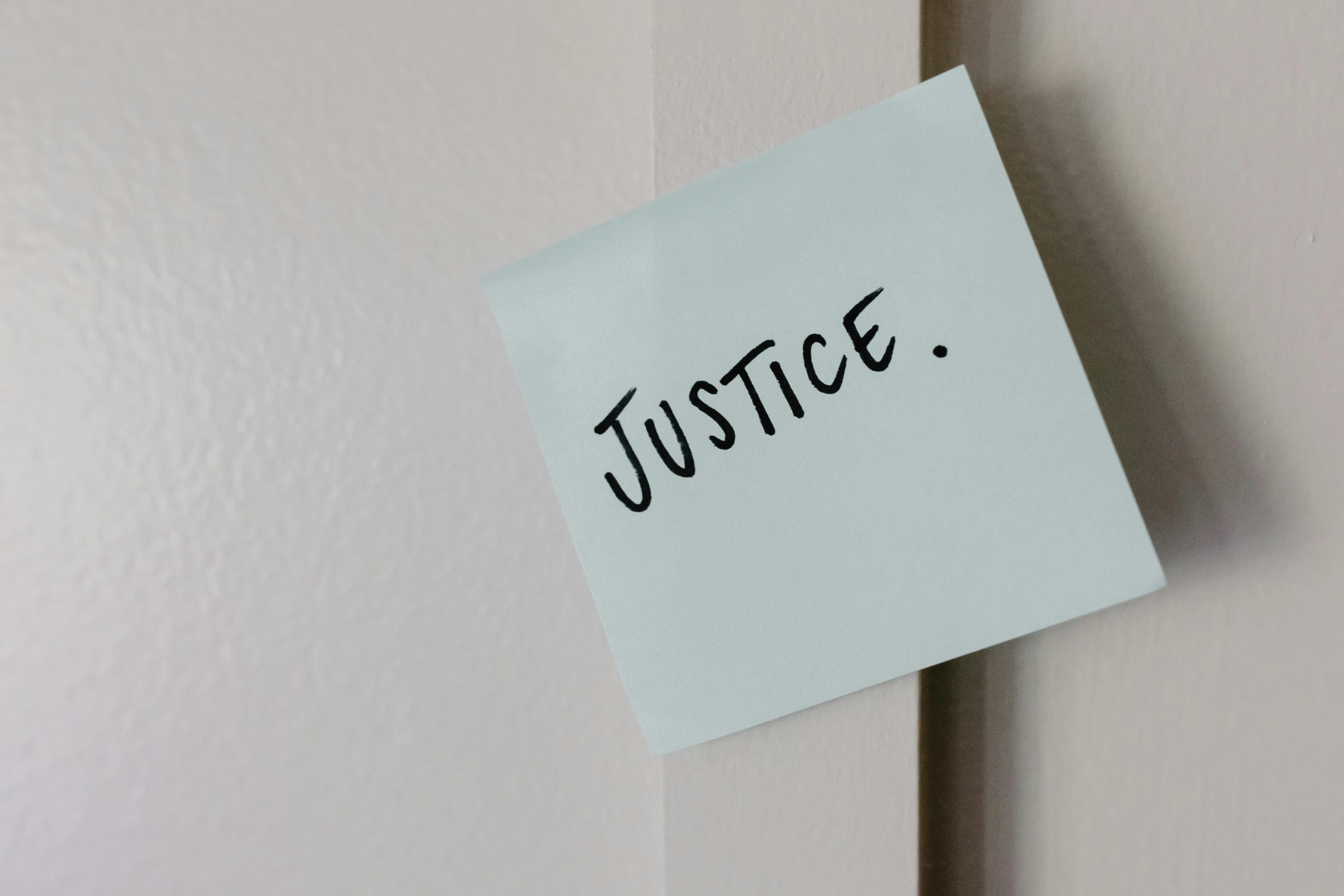 a piece of paper with the word justice written on it, a cartoon, unsplash, hung above the door, heroism, light-blue, a list cast