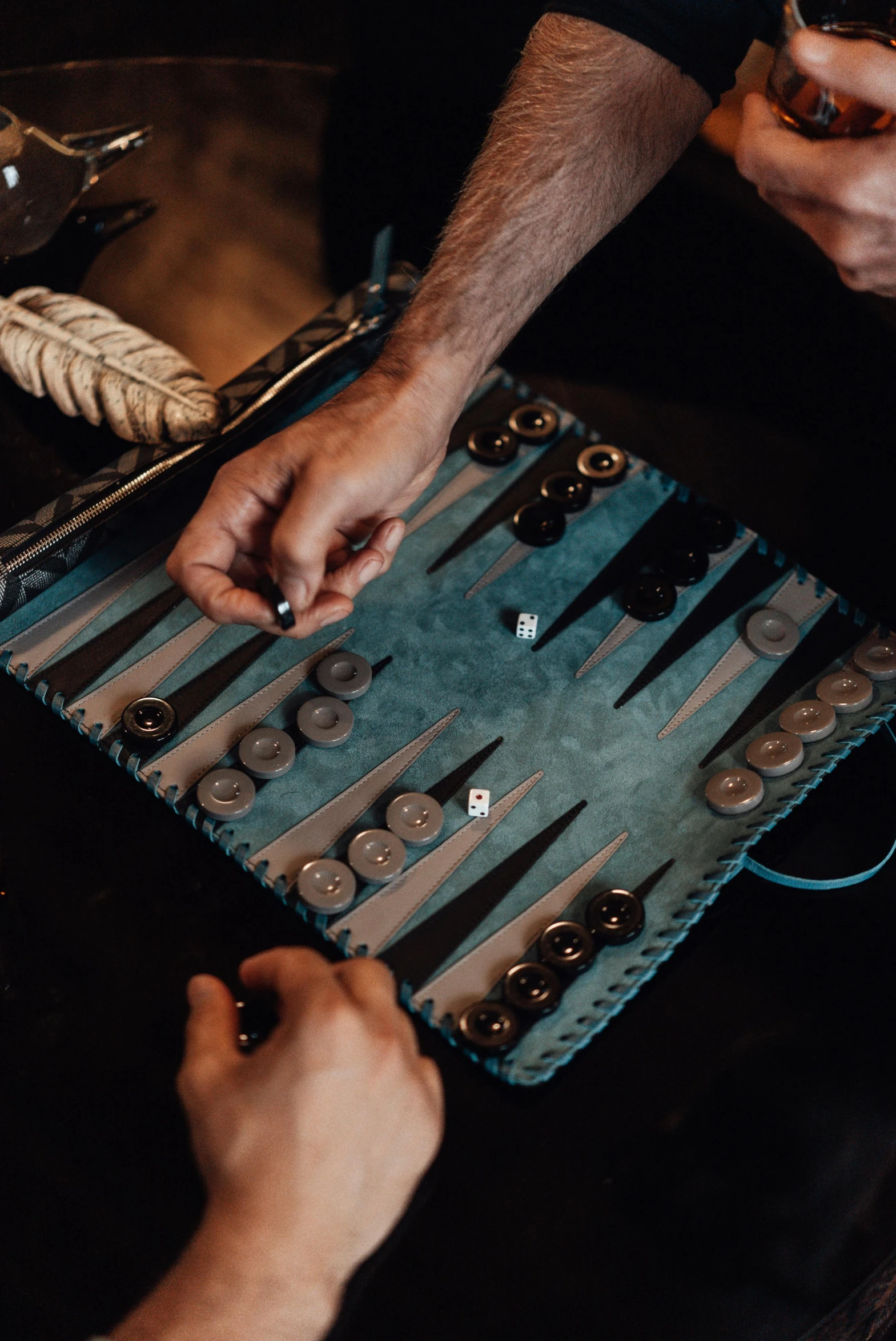 two men are playing a game of backgams, pexels contest winner, leather pouch, blue and grey, buttons, thumbnail