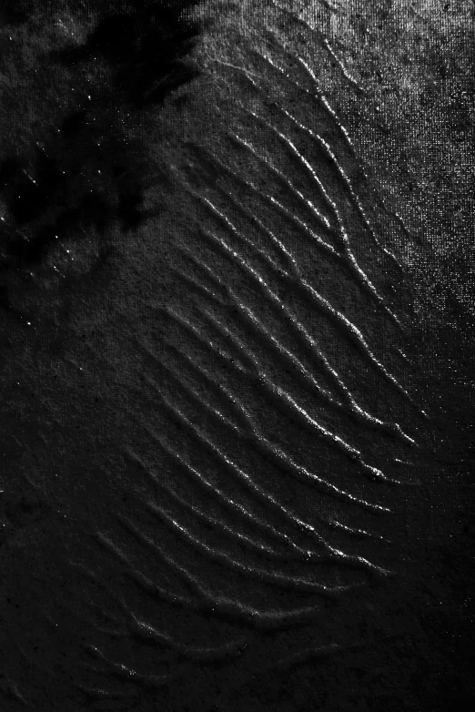 a black and white photo of waves in the sand, a stipple, inspired by Edward Weston, lyrical abstraction, on the surface of an asteroid, /r/earthporn, abstract album cover, scratches on photo