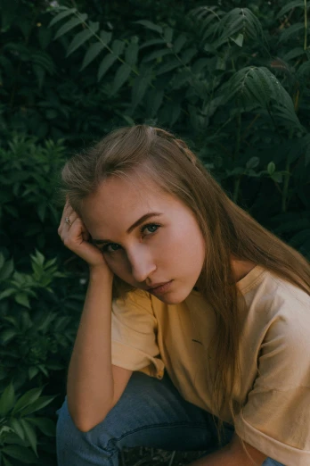 a girl sitting on the ground in front of a bush, a picture, inspired by Elsa Bleda, trending on pexels, realism, thick jawline, anna nikonova aka newmilky, headshot profile picture, serious face