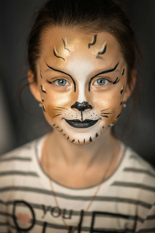 a little girl with her face painted like a cat, an airbrush painting, by Julia Pishtar, trending on pexels, wearing golden cat armor, teenage girl, striped, lovely detailed faces
