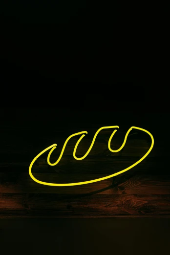 a neon sign sitting on top of a wooden table, sliced banana, rounded lines, jörmungandr, mono-yellow