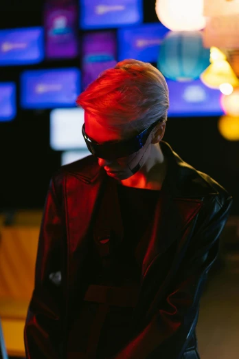 a man standing in front of a laptop computer, an album cover, inspired by Tadashi Nakayama, trending on pexels, short platinum hair tomboy, cyber noir, dramatic lights, television sunglasses