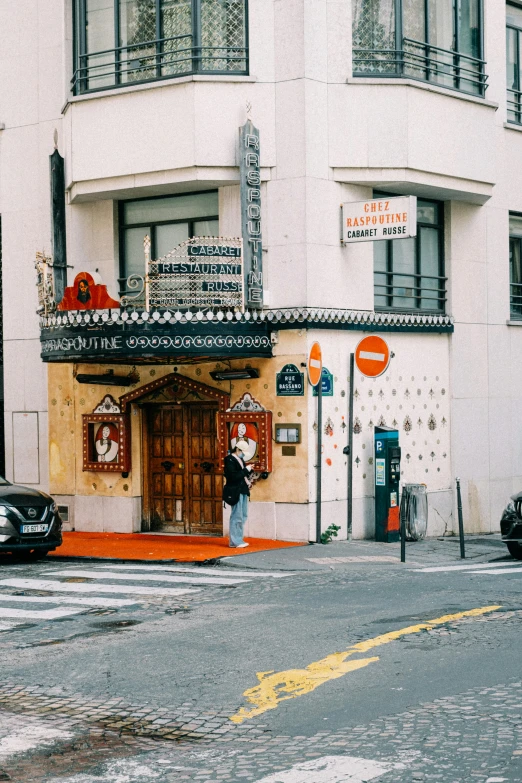 a couple of cars that are parked in front of a building, trending on unsplash, paris school, indian temple, exiting store, white and orange, masked person in corner