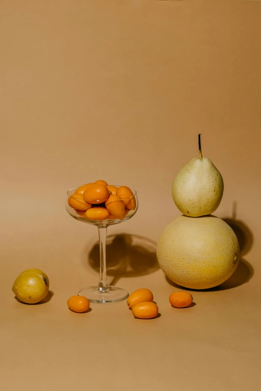 a group of fruit sitting on top of a table, inspired by Giorgio Morandi, unsplash contest winner, orange yellow ethereal, glassware, smooth oval head, ignant