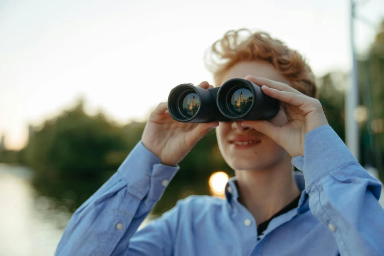 a man looking through a pair of binoculars, a picture, shutterstock, visual art, future coder man looking on, looking towards camera, vision quest, visualisation