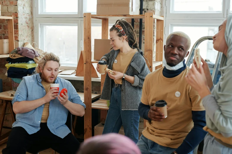 a group of people standing in a room, trending on pexels, arbeitsrat für kunst, celebration of coffee products, playful smirk, a wooden, avatar image