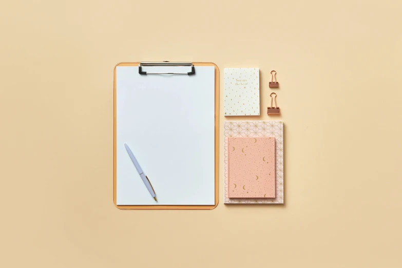 a notepad sitting on top of a clipboard next to a pen, a picture, pale orange colors, square shapes, product image, knolling