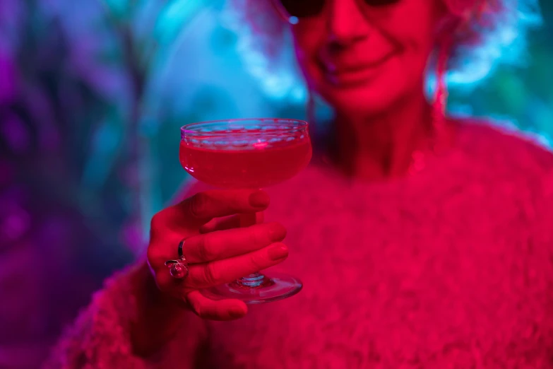 a close up of a person holding a wine glass, inspired by Elsa Bleda, funk art, fuschia leds, cocktail bar, 70s psychedelic style, holiday vibe