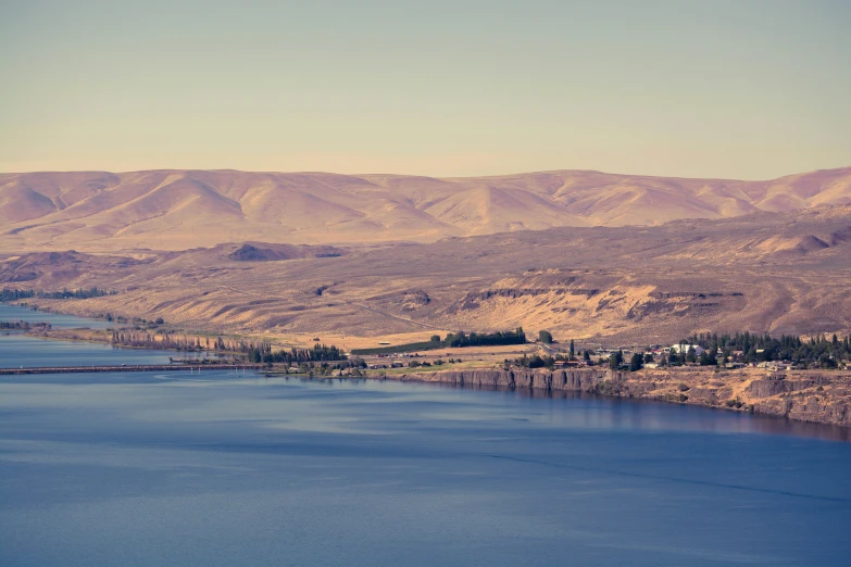 a large body of water surrounded by mountains, pexels contest winner, hurufiyya, assyrian, cornell, background image, sunfaded