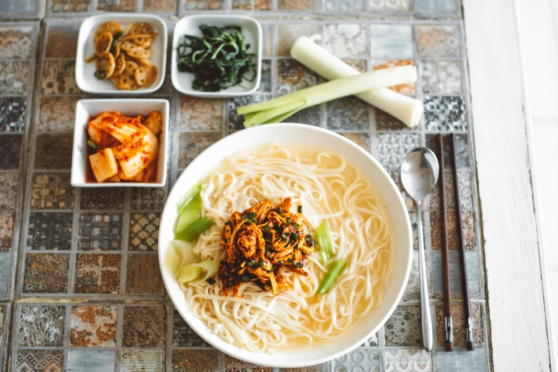 a bowl of noodles sitting on top of a table, inspired by Nam Gye-u, pexels contest winner, square, hong soonsang, white, thumbnail