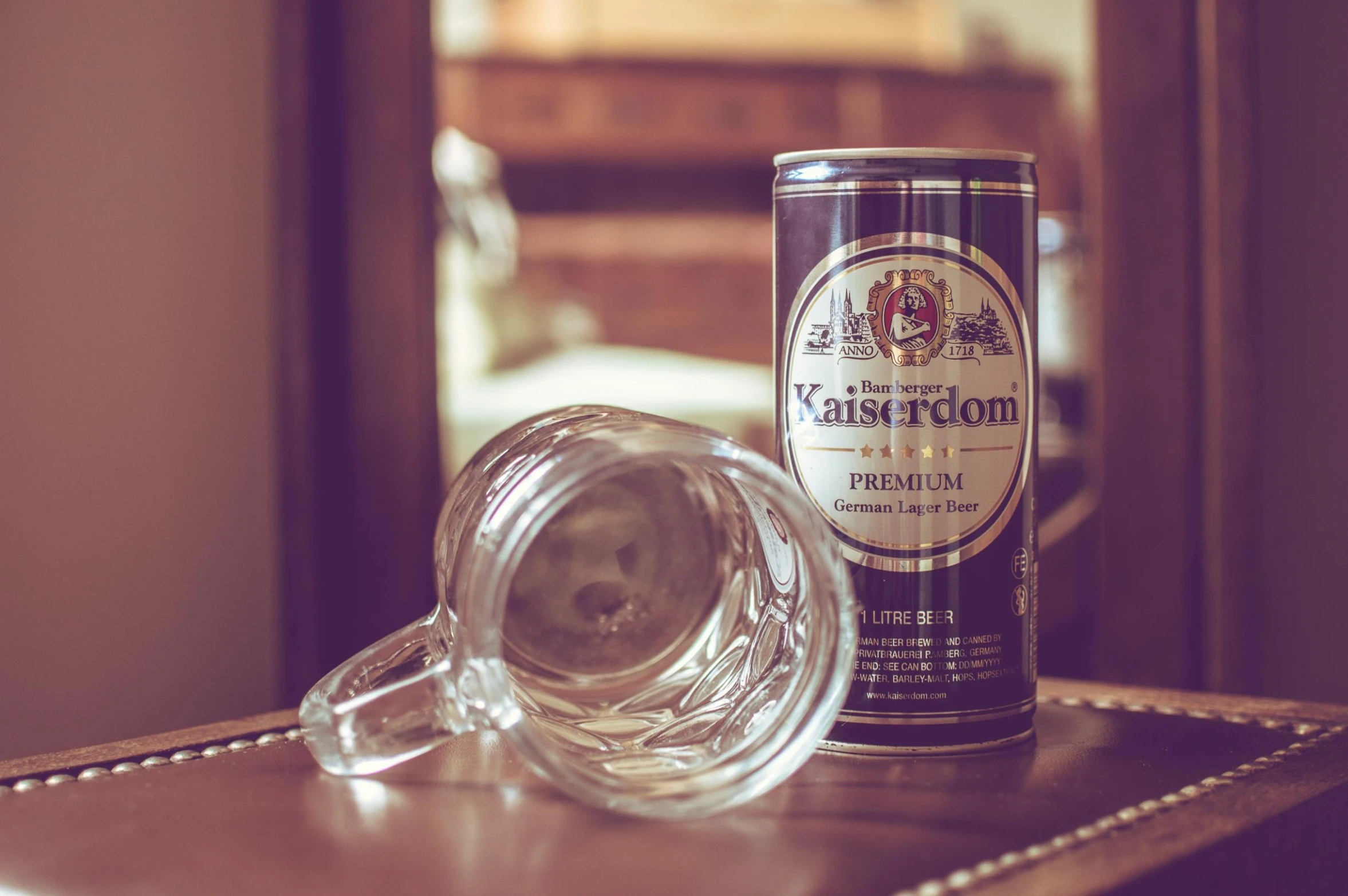 a beer can sitting on top of a table next to a glass, inspired by Karl Hagedorn, unsplash, photorealism, hotel room, kashin, classic gem, the backroom