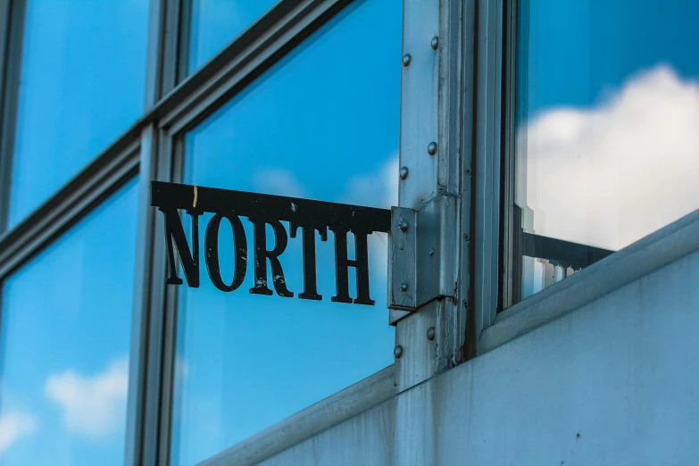 a street sign on the side of a building, by Niko Henrichon, unsplash, northwest school, planet hoth, train window, norse, high details photo