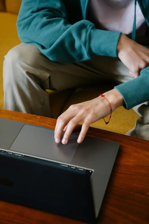 a person sitting on a couch using a laptop, across holding a hand, digital image, student, ignant