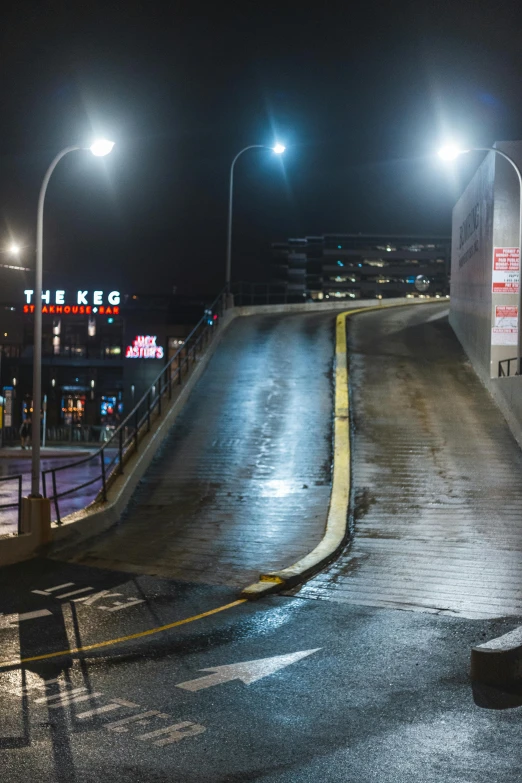 a man riding a skateboard down a street at night, by Eero Snellman, reddit, bus station, ramps, viking city, empty road in the middle