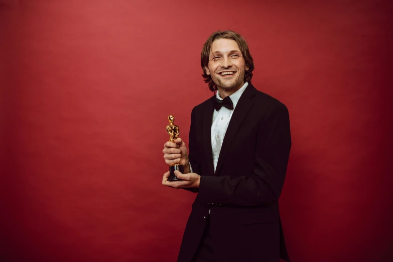 a man in a tuxedo holding an award, a portrait, by Meredith Dillman, pexels contest winner, crewdson, andy samberg, avatar image, orthodox