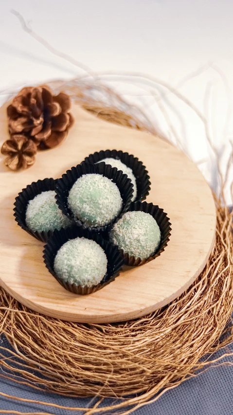 a close up of a plate of food on a table, flying black marble balls, gradient pastel green, kuntilanak, snowy