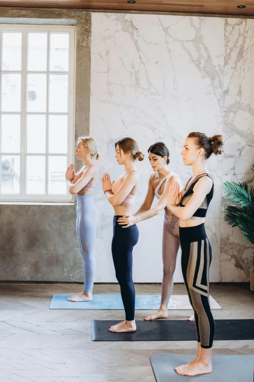 a group of women standing in a yoga pose, pexels contest winner, renaissance, curated collections, low quality photo, praying posture, slim