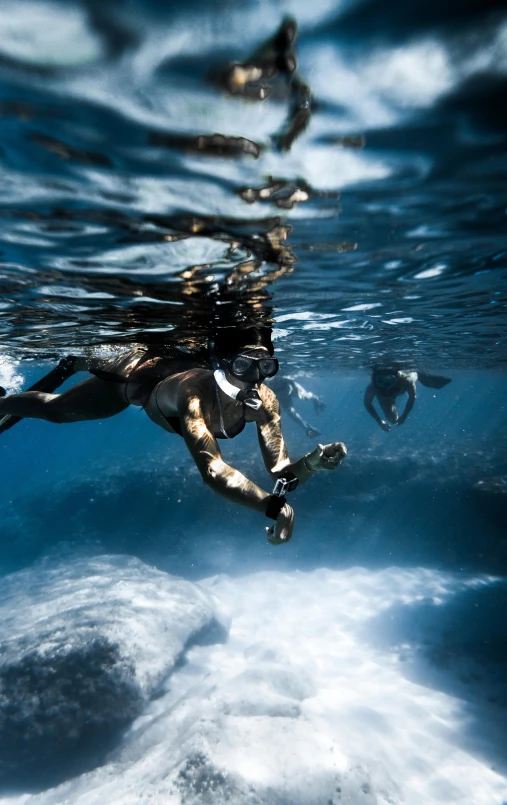 a person swimming in the ocean with a surfboard, underwater life, shot with sony alpha, pirates, high-quality photo