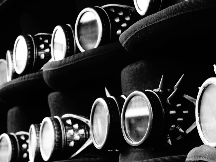 a bunch of hats sitting on top of a shelf, a black and white photo, by Konrad Krzyżanowski, unsplash, surrealism, steampunk goggles, steampunk world spikes, round headlights, vintage - w 1 0 2 4