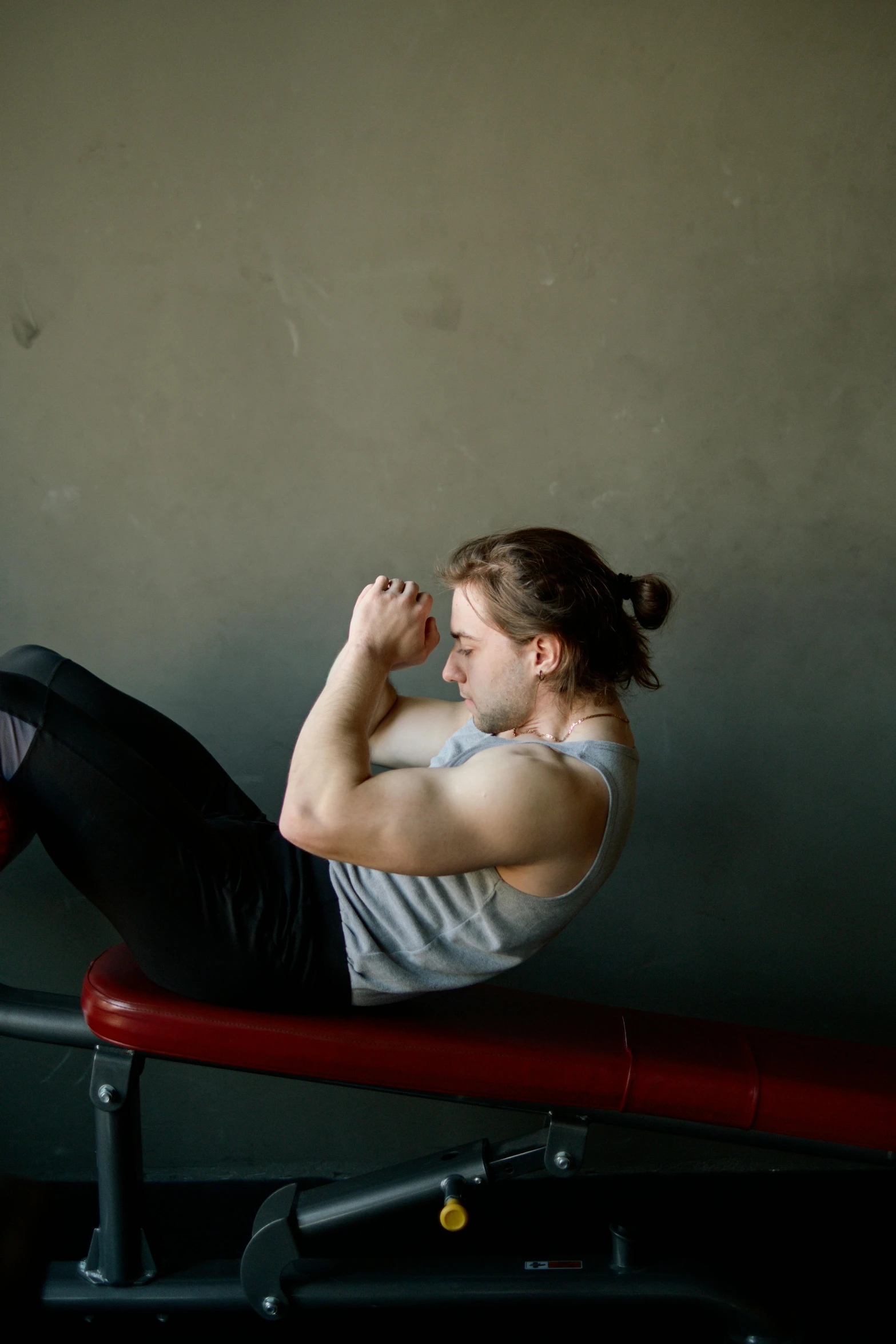 a woman sitting on top of a red bench, muscular male, profile image, caleb worcester, sweat