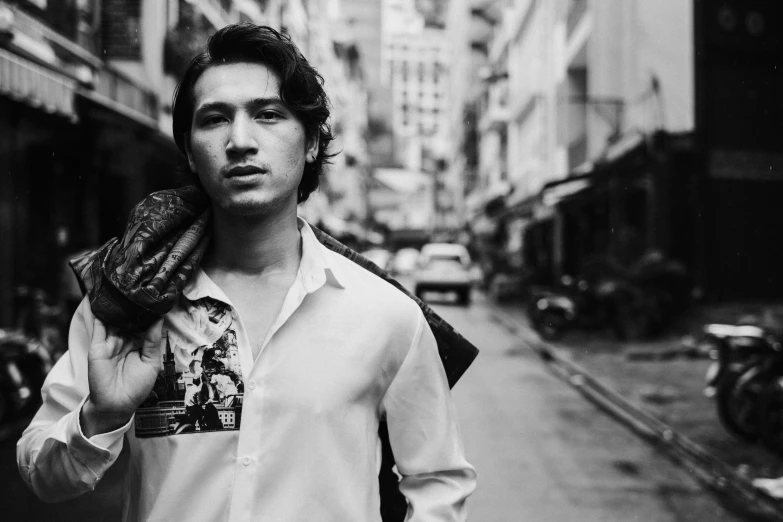 a black and white photo of a man walking down a street, pexels contest winner, portrait of beautiful young man, bangkok, avan jogia angel, gif