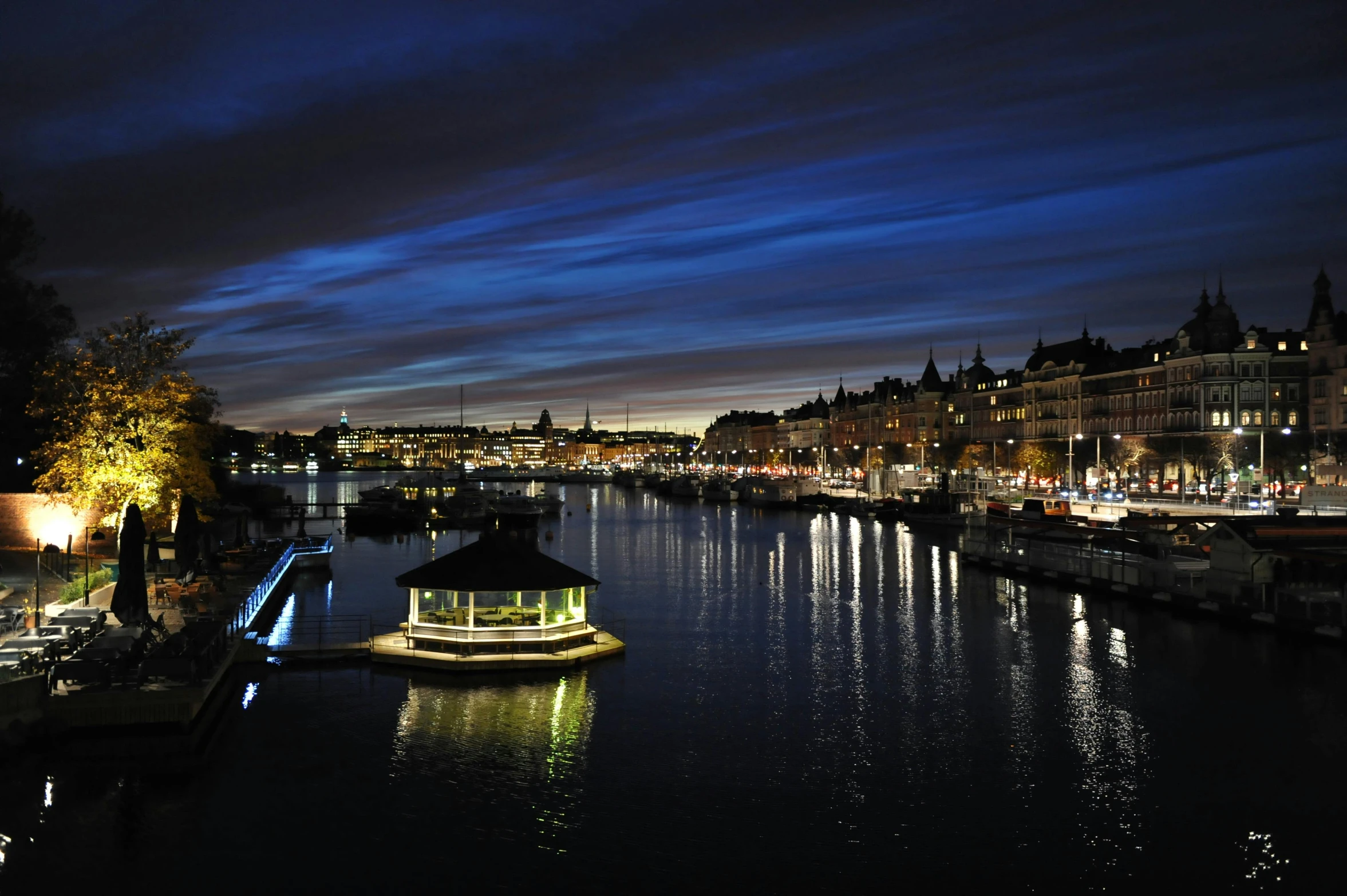 a boat that is sitting in the water, by Jesper Knudsen, pexels contest winner, hurufiyya, the river is full of lights, olafur eliasson, victorian harbour night, ikea