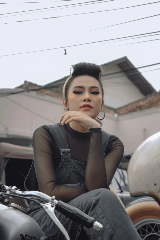 a woman sitting on the back of a motorcycle, an album cover, inspired by Rudy Siswanto, trending on pexels, realism, androgynous face, mean look, fashion shoot 8k, grainy