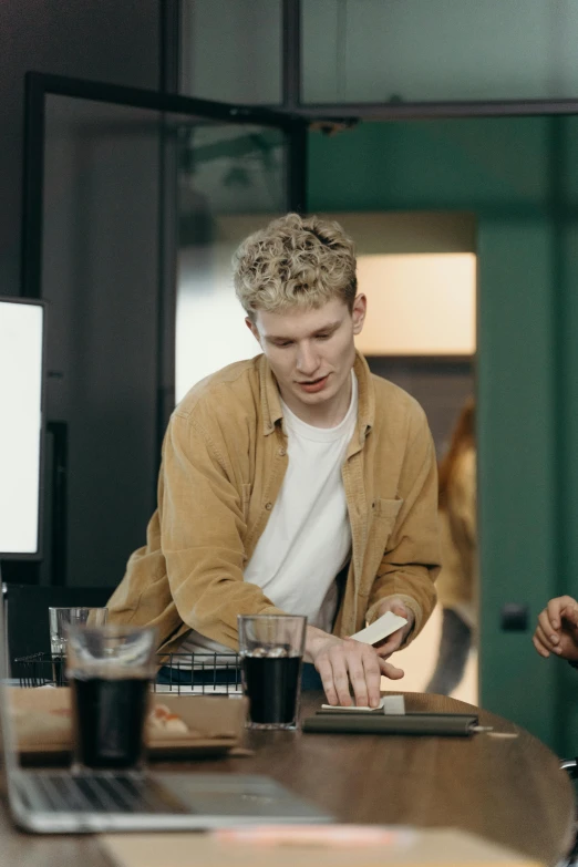 a group of men sitting around a wooden table, trending on pexels, hyperrealism, one man is blond, at the counter, color footage, promotional image