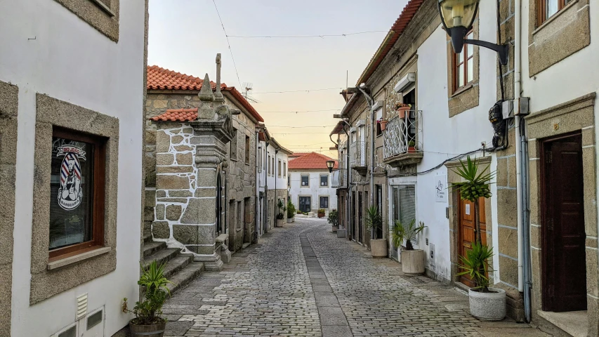 a cobblestone street in an old european town, inspired by Juan de Valdés Leal, pexels contest winner, art nouveau, alvaro siza, square, medieval coastal village, grey
