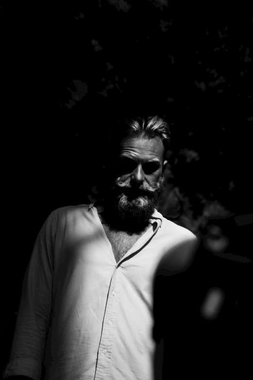 a black and white photo of a man with a beard, a black and white photo, by Constantine Andreou, medium format. soft light, malcom liepke, vector image, jeff bridges