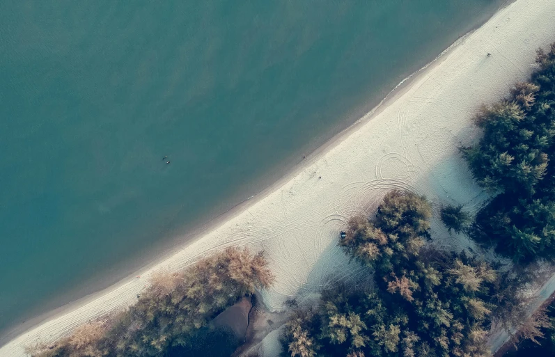 an aerial view of a beach next to a body of water, by Adam Marczyński, secluded, 3delight, shoreline, simplistic