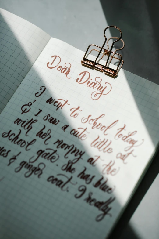 a note sitting on top of a piece of paper, with some hand written letters, daily carry, beautiful light, thumbnail