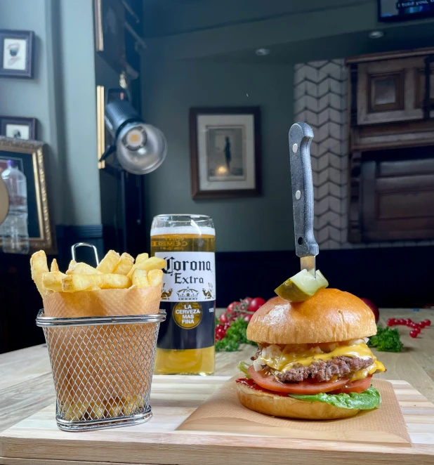 a burger sitting on top of a wooden cutting board, inspired by Richmond Barthé, house bolton, drinking, thumbnail, with fries