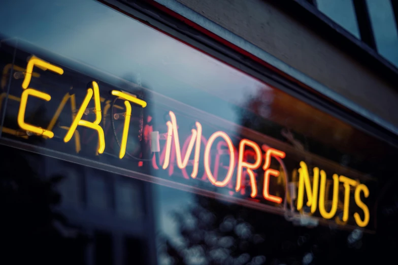 a neon sign that says eat more nuts, by Nick Fudge, pexels contest winner, diner scene, more scars, stathmore 2 0 0, thumbnail