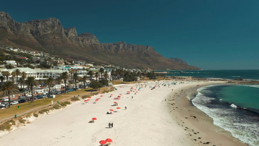 a beach filled with lots of umbrellas next to the ocean, by Daniel Lieske, pexels contest winner, royal cape, surrounding the city, slim aarons, from of thrones