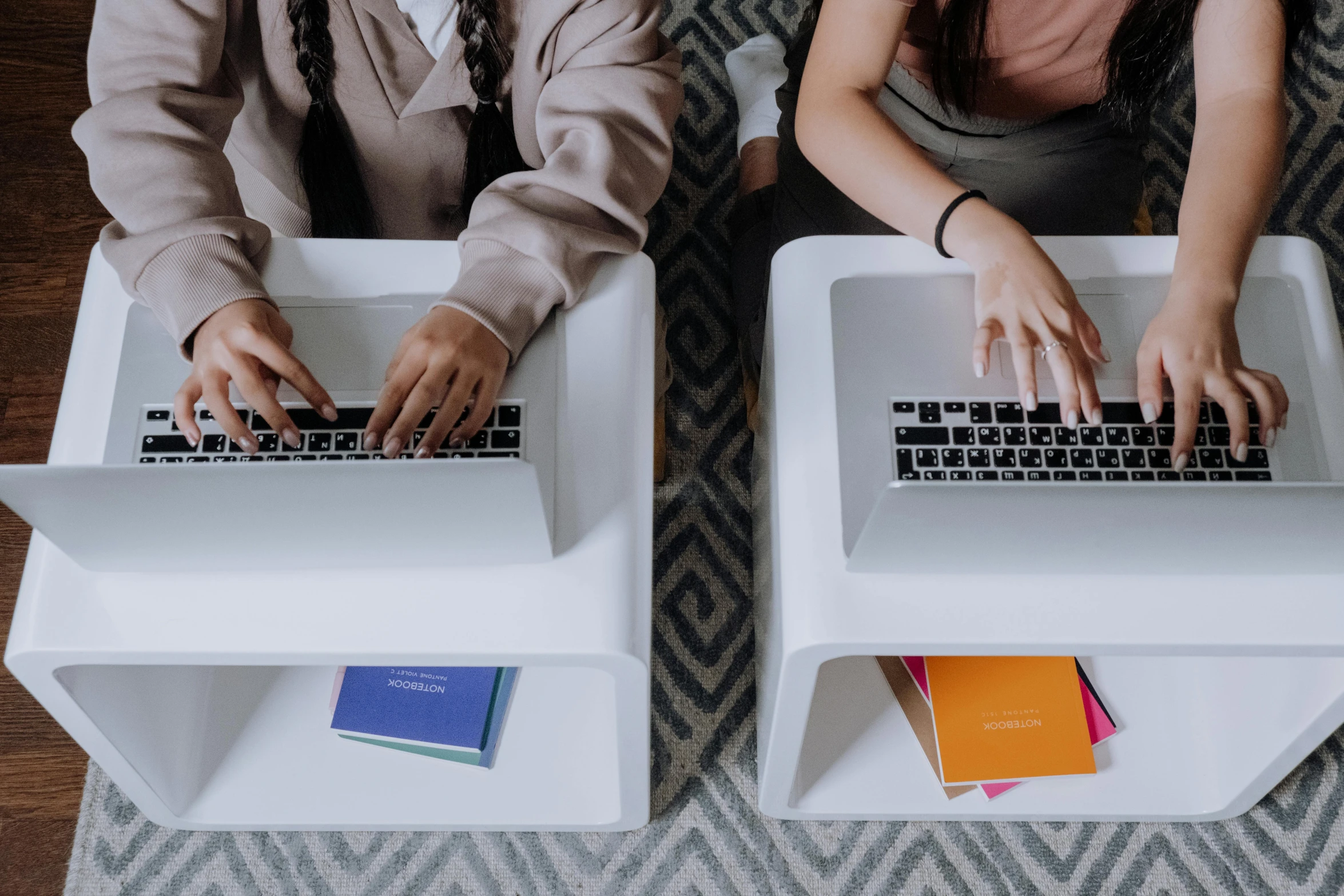 a couple of people sitting next to each other on laptops, trending on pexels, bottom angle, schools, 9 9 designs, standing straight