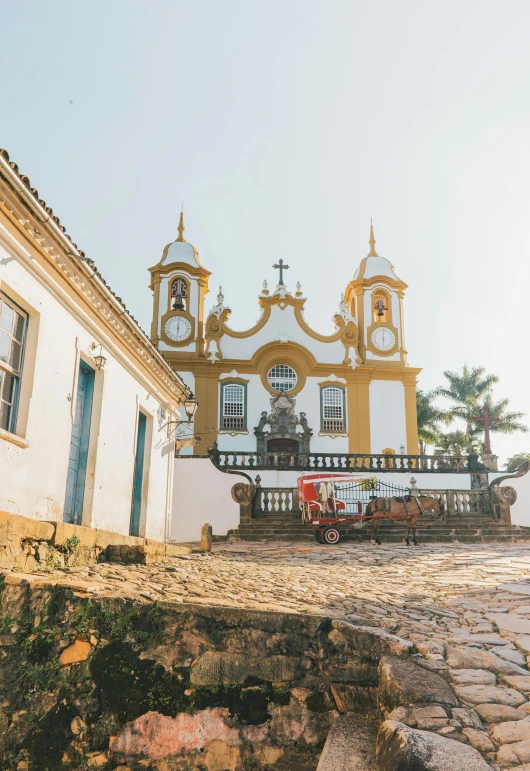 a cobblestone street with a church in the background, by Daniel Lieske, trending on unsplash, baroque, brazil, 2 5 6 x 2 5 6 pixels, white and gold color palette, small port village