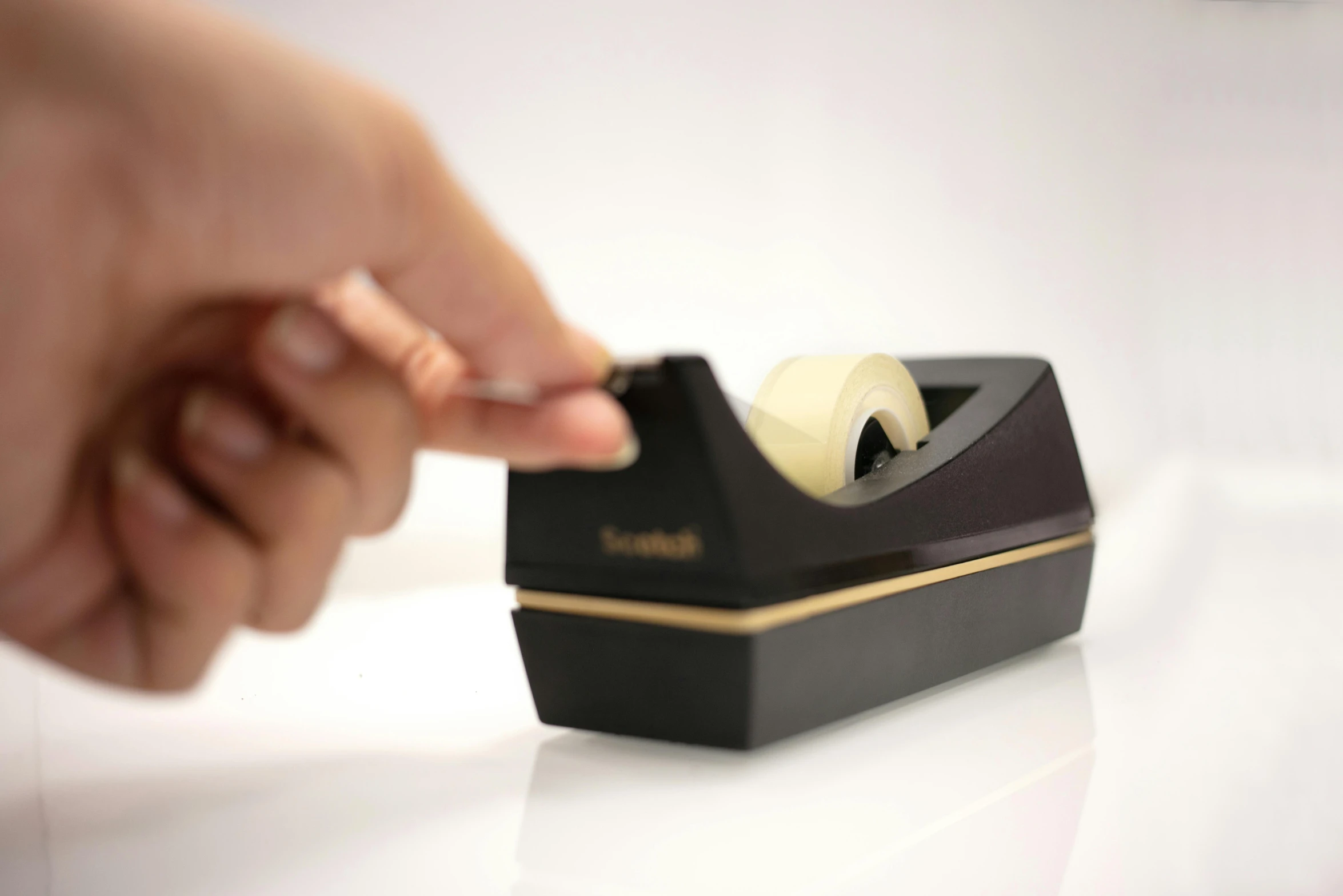 a close up of a person holding a tape dispenser, black and gold, top lid, highly upvoted, sienna