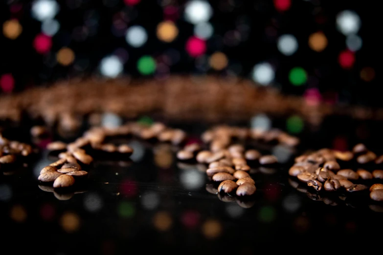 a pile of coffee beans sitting on top of a table, dazzling lights, taken with sony alpha 9, coffee art, medium shot taken from behind