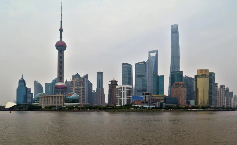 a large body of water with a city in the background, by Zha Shibiao, pexels contest winner, chinese building, big towers, 2000s photo, panoramic