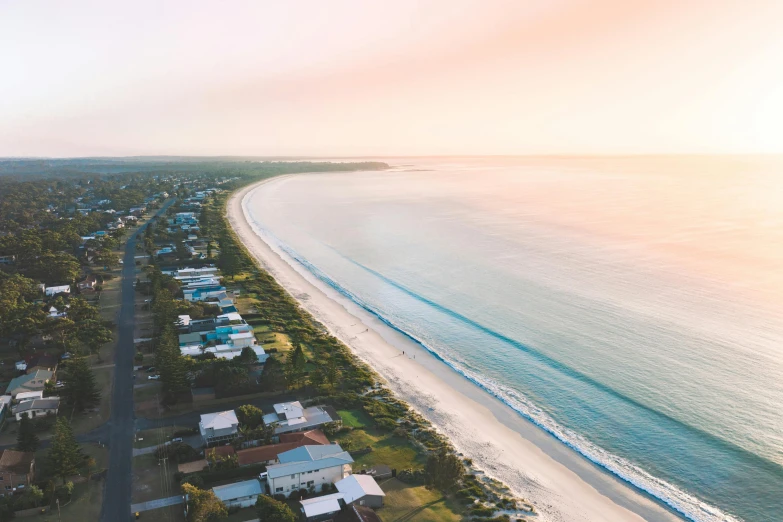 an aerial view of a beach with houses in the foreground, by Lee Loughridge, unsplash contest winner, looking into the horizon, soft glow, lachlan bailey, ultrawide lens”