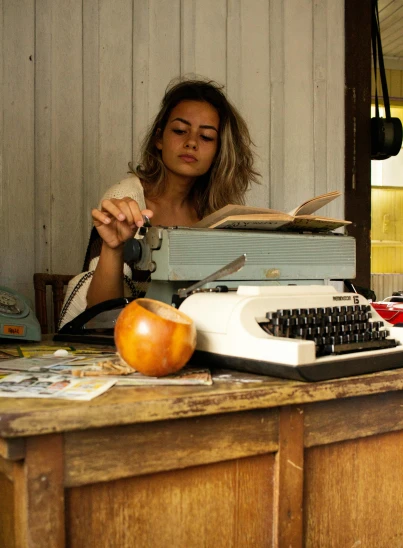 a woman is typing on an old typewriter, inspired by Elsa Bleda, cuban setting, 2019 trending photo, cottage hippie naturalist, looking seductive