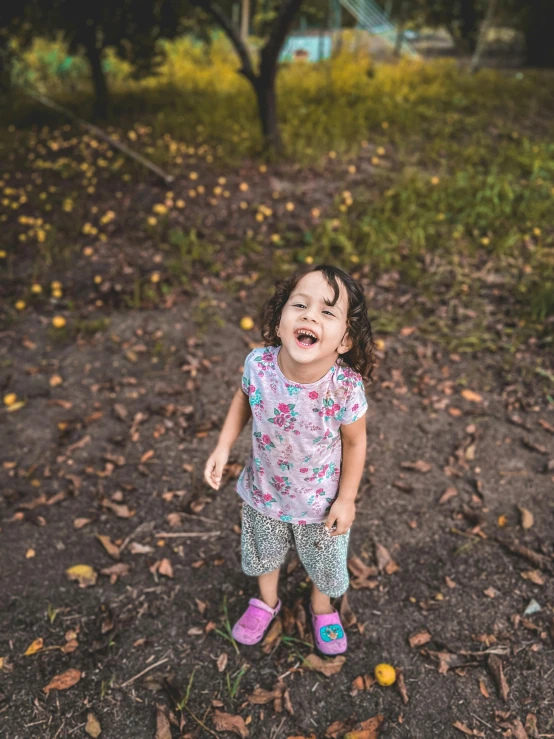 a little girl that is standing in the dirt, manically laughing, taken in 2 0 2 0, fan favorite, low quality photo